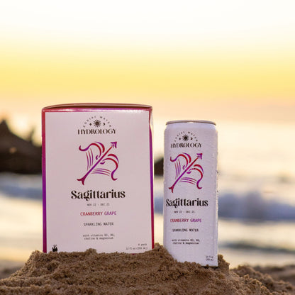 Sagittarius astrology themed beverage 4-pack and can in sand at beach